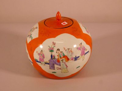 an orange and white vase with a picture of people on it