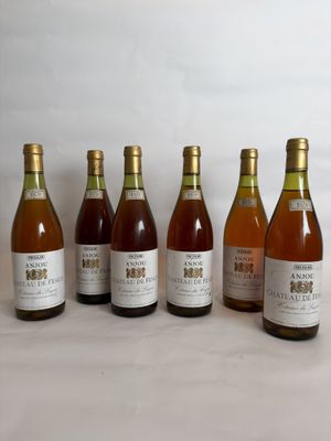 six bottles of wine are lined up in a row on a table