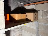 a box that is sitting on a shelf in the corner of a room
