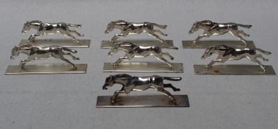 six figurines en argent représentant des chevaux au galop sur un fond blanc