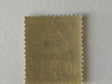 a close up of a gold stamp on a white surface
