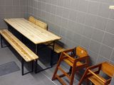 a room with a table, chairs, and a television in it