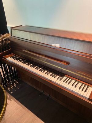 a piano that is sitting in the corner of a room