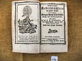un vieux livre sur lequel est représenté un homme assis