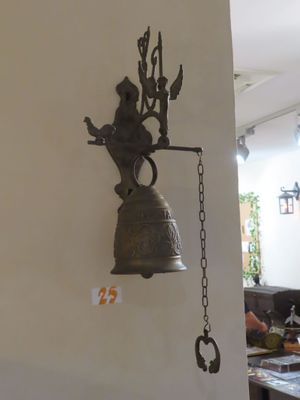 une cloche accrochée au mur d'un restaurant