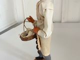 a figurine of a man holding a basket of eggs
