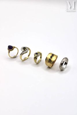 five different types of rings on a white surface