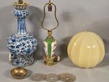 three vases and a lamp on a table