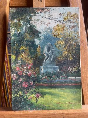 a painting of a statue in a garden on a easel