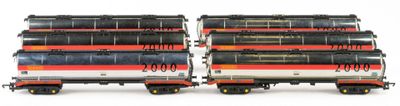two trains that are sitting side by side on a white surface