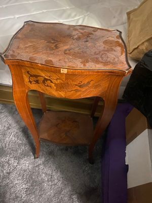 a small wooden table with a drawer on top of it