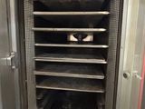 an image of a commercial oven with trays in it