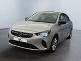 the front view of a silver car in a white room