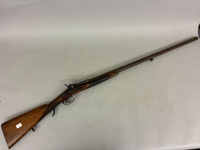 a rifle that is on a table with a knife in it