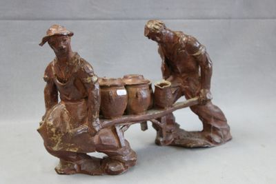 two figurines of a man and a woman pulling a wagon
