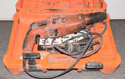 une mallette à outils orange contenant une perceuse et d'autres outils
