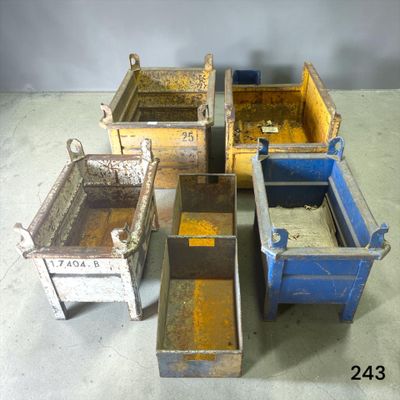 several metal bins are lined up in a row on the floor