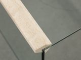 a close up of a glass table with a wooden handle