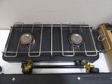 a stove with two burners sitting on top of it