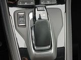 a close up of a car ' s center console with a phone in it