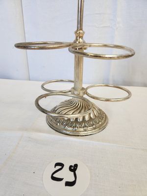 a silver candle holder on a table with a number on it
