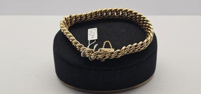 un bracelet en chaîne d'or dans un coffret en velours noir