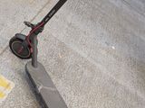 a scooter that is sitting on the sidewalk