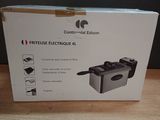 boxed box of a deep fryer sitting on a wooden table