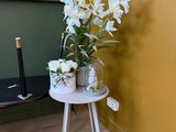 a small table with a vase of flowers on it
