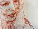 drawing of a woman ' s face in red ink on a piece of paper