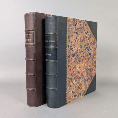 two books sitting on top of each other on a white surface