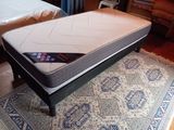 a mattress that is sitting on a rug on the floor