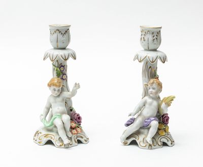 two figurines that are sitting next to each other