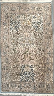 an antique persian rug with a floral design on a blue background