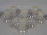 a lot of glass candles that are sitting on a table