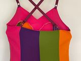 purple, green, orange, and pink dress hanging on a hanger