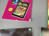 a lot of books on the table with pictures on them