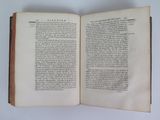 an open book on a table with a white background