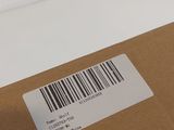 an open box with a barcode on it sitting on a table