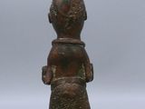 an old bronze figurine of a man with a hat on his head
