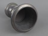 an antique silver vase on a gray surface