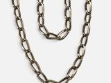 a necklace and bracelet set with a long chain on a white background
