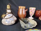 many different types of vases and bowls on the table