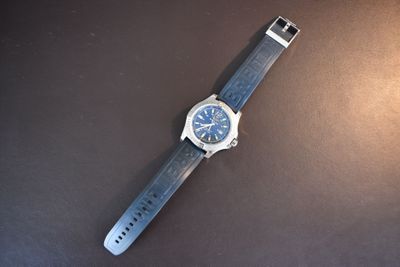 an image of a watch sitting on top of a black surface
