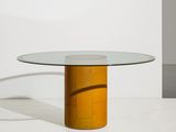 an image of a glass table with a wooden base and a round glass top