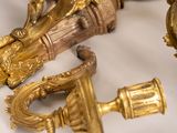 a lot of gold colored objects on a white surface