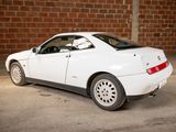 a picture of a white car parked in a garage