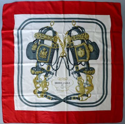 a picture of a red and white scarf with a picture of two knights on it