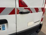 a white van with red stripes parked in a parking lot