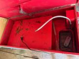 a red box with a metal handle and a wire in it